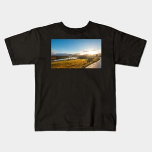 Beautiful norwegian scenery. Mountains in background. Horses are on the farm near river Kids T-Shirt